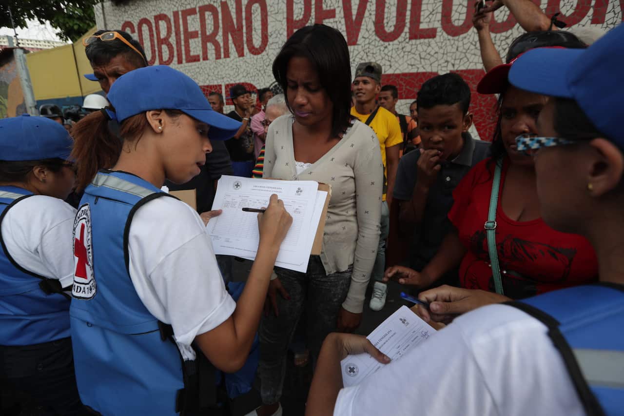 Members of the Red Cross distribute their first shipment of humanitarian aid in Caracas, Venezuela.