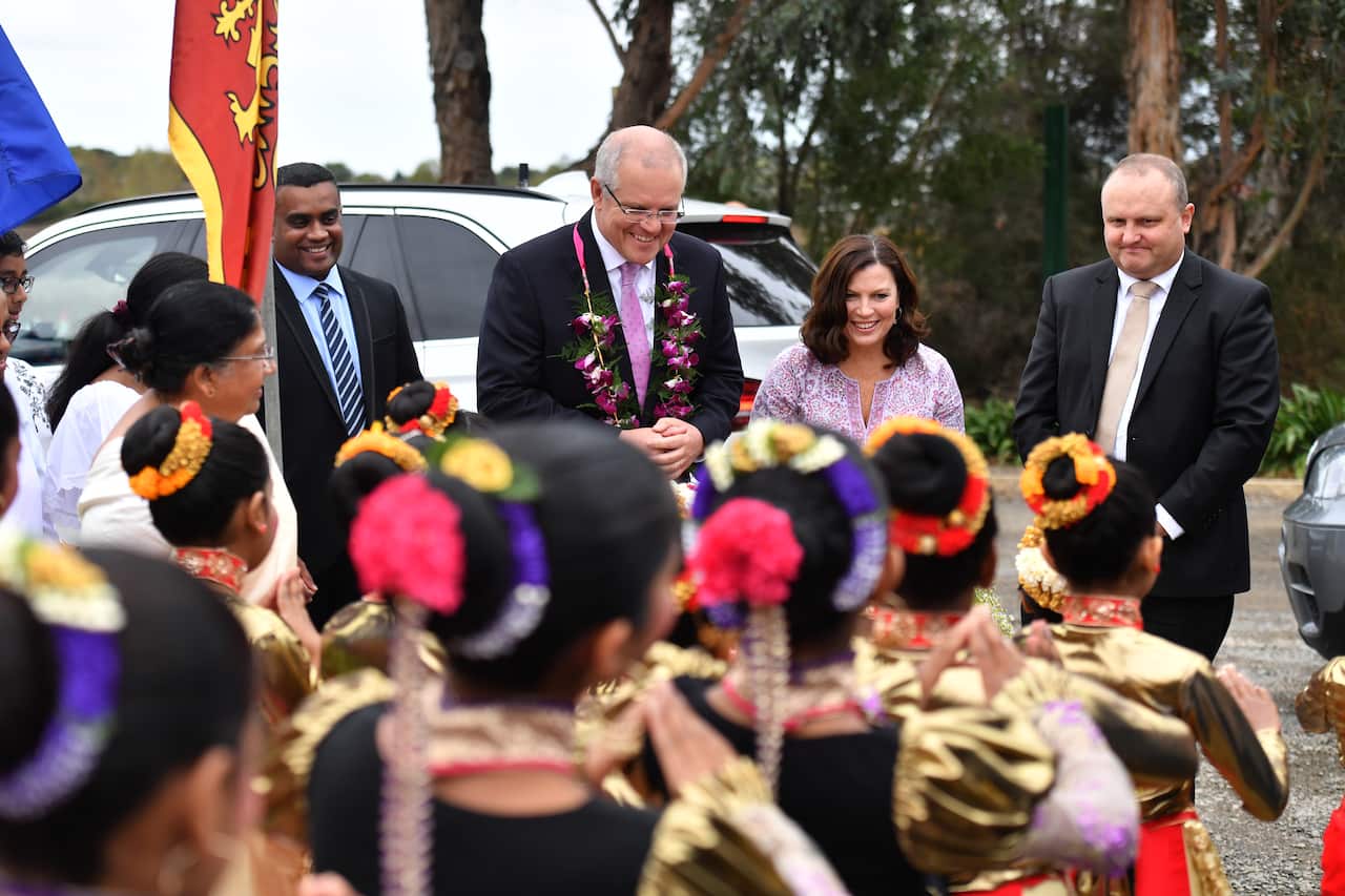 Prime Minister Scott Morrison, wife Jenny and Liberal member for Latrobe Jason Wood visit the Sakyamuni Sambuddha Vihara, Sri Lankan Buddhist Temple, in Berwick in Melbourne, Monday, April 22, 2019. (AAP Image/Mick Tsikas) NO ARCHIVING