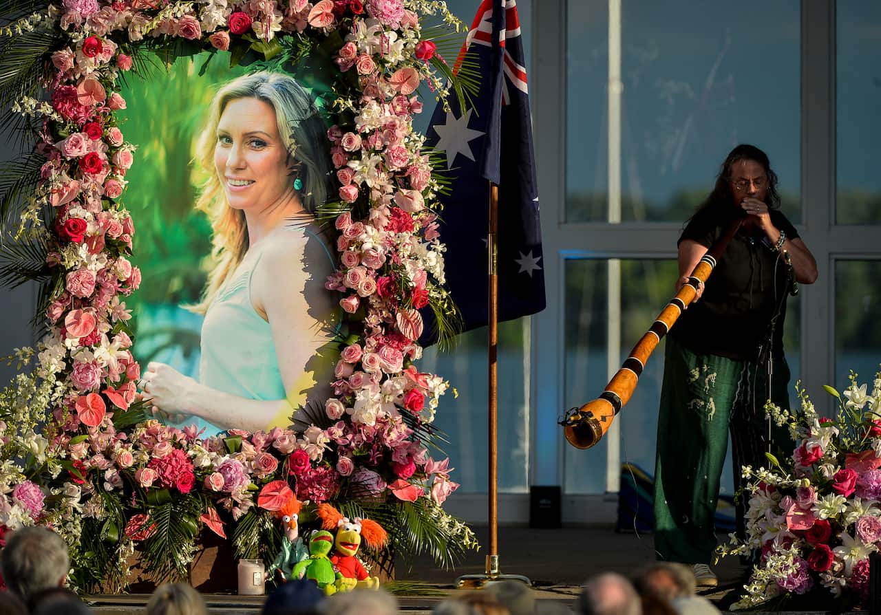  Johanna Morrow plays the didgeridoo during a memorial service for Justine Damond at Lake Harriet in Minneapolis.