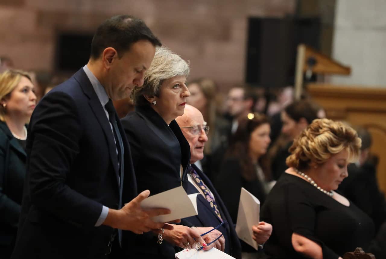 Prime Minister Theresa May and President Michael D Higgins before the funeral service.