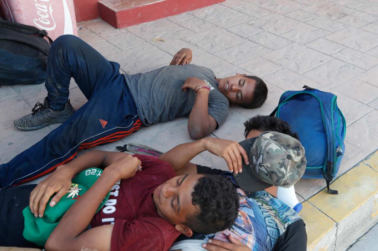 Central American migrants rest near the railroad tracks during their journey toward the US-Mexico border in Chahuites, Oaxaca state, Mexico.