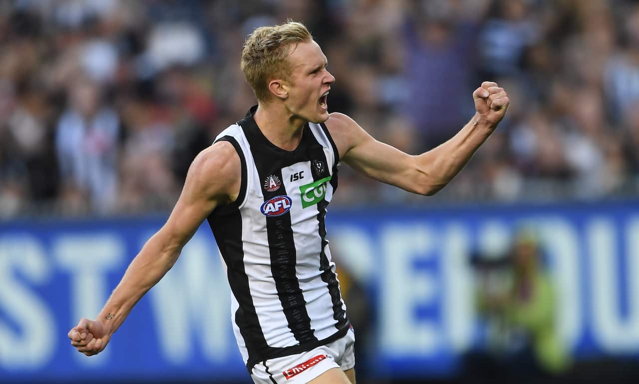 Jaidyn Stephenson of the Magpies reacts after kicking a goal.
