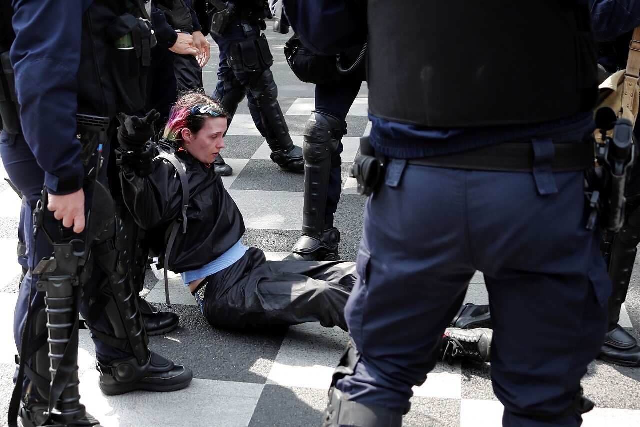 A protester is arrested by French riot police.