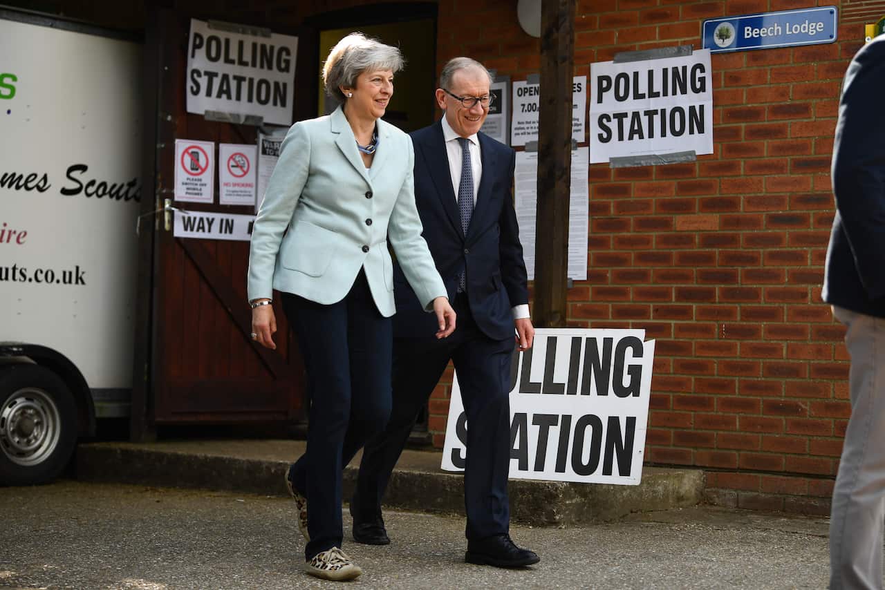 UK Prime Minister Theresa May and her husband, Philip, arrive to cast their votes at a polling station.