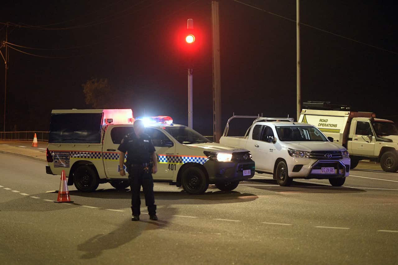 Police at a crime scene on the intersection of McMinn Street and Stuart Highway in Darwin following the shootings.