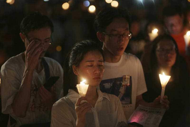 People attend a candlelight vigil three decades on from the Chinese government's military crackdown on protesters in Beijing's Tiananmen Square