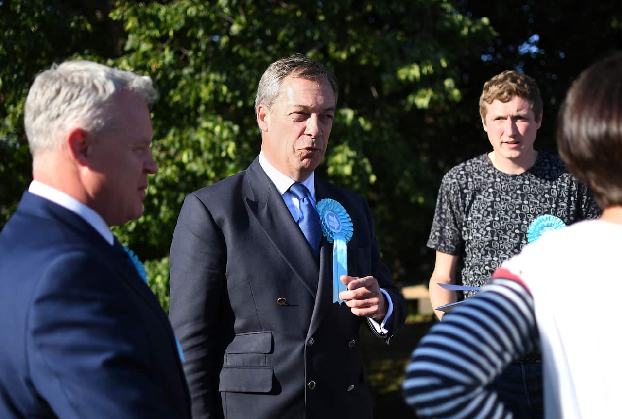 Brexit Party leader Nigel Farage with party candidate Mike Greene as they 'door knock' in Newborough in Peterborough.