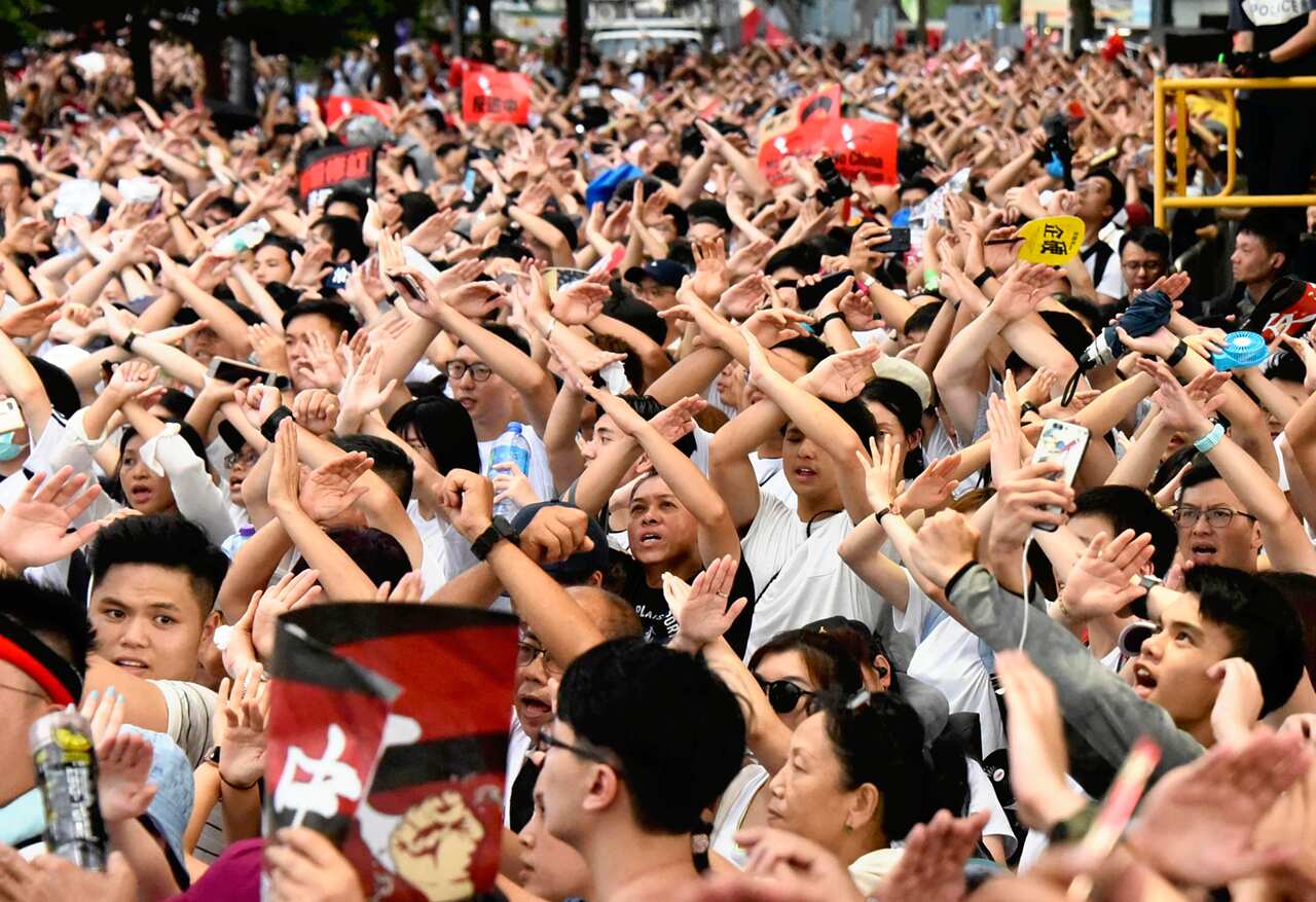 Hong Kong citizens march through the streets in a massive protest against China's extradition law.