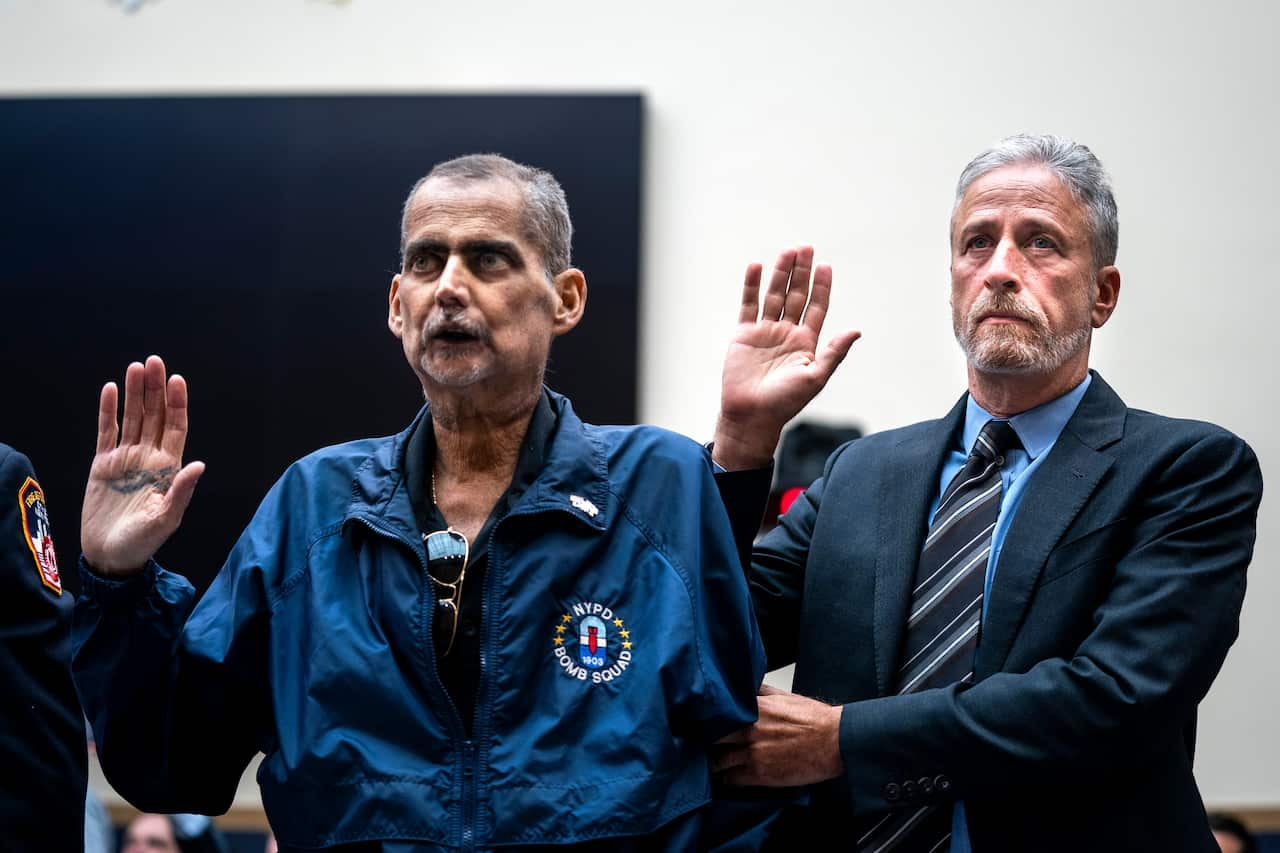 Stewart steadies former NYPD Bomb Squad Detective Louis Alvarez, who contracted cancer working on Ground Zero after the September 11 attack.