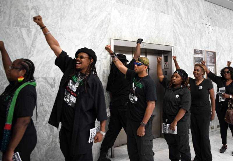 Members of the New Black Panther Party gathered in the hallway outside the hearing 
