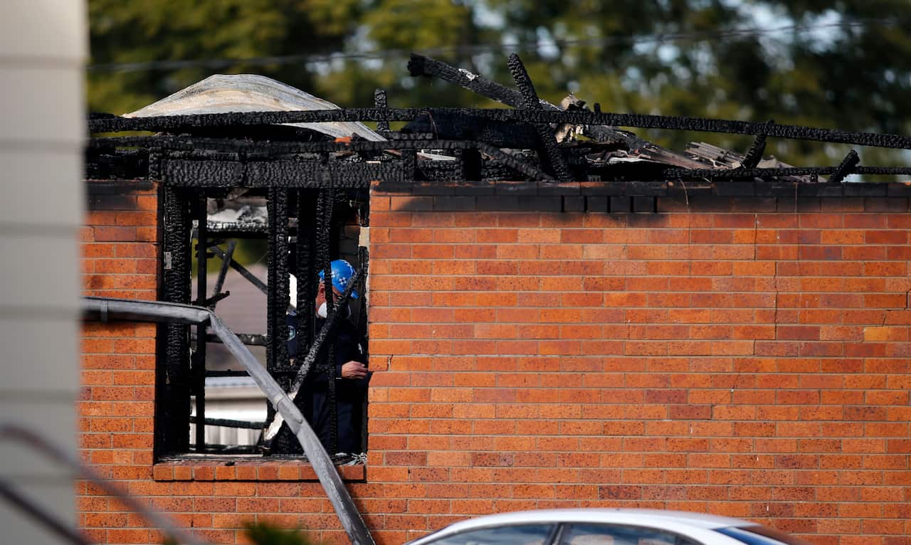 PHOTO: Investigators at the site of a fatal house fire in Singleton, NSW, Wednesday, June 26, 2019. Two girls and a boy have died following a house fire in Singleton in the NSW Hunter Valley.