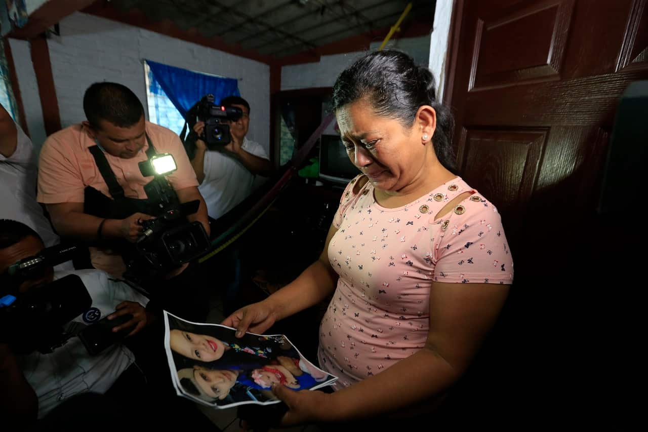 Rosa Ramirez cries when shown a photograph printed from social media of her son and granddaughter.