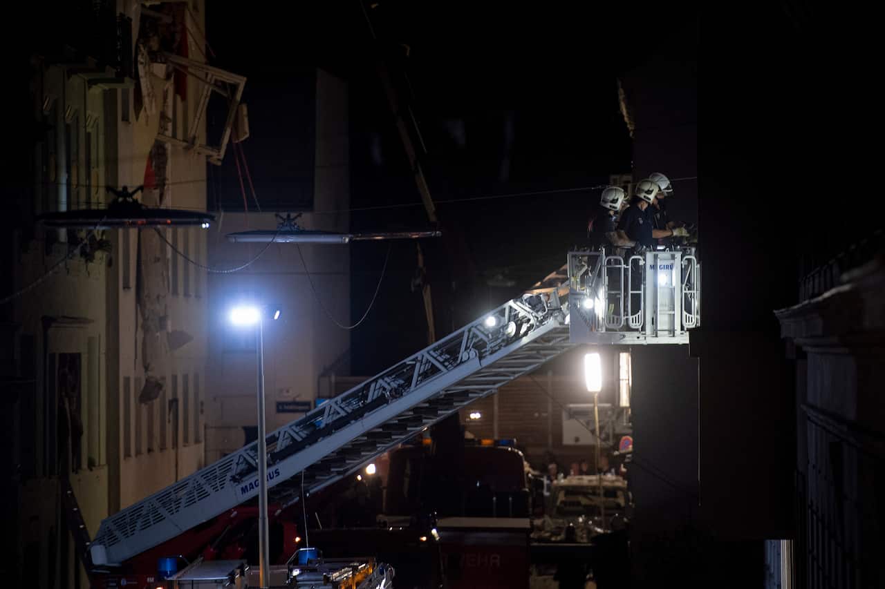 Members of the emergency services at the site of a partial collapsed building in Vienna