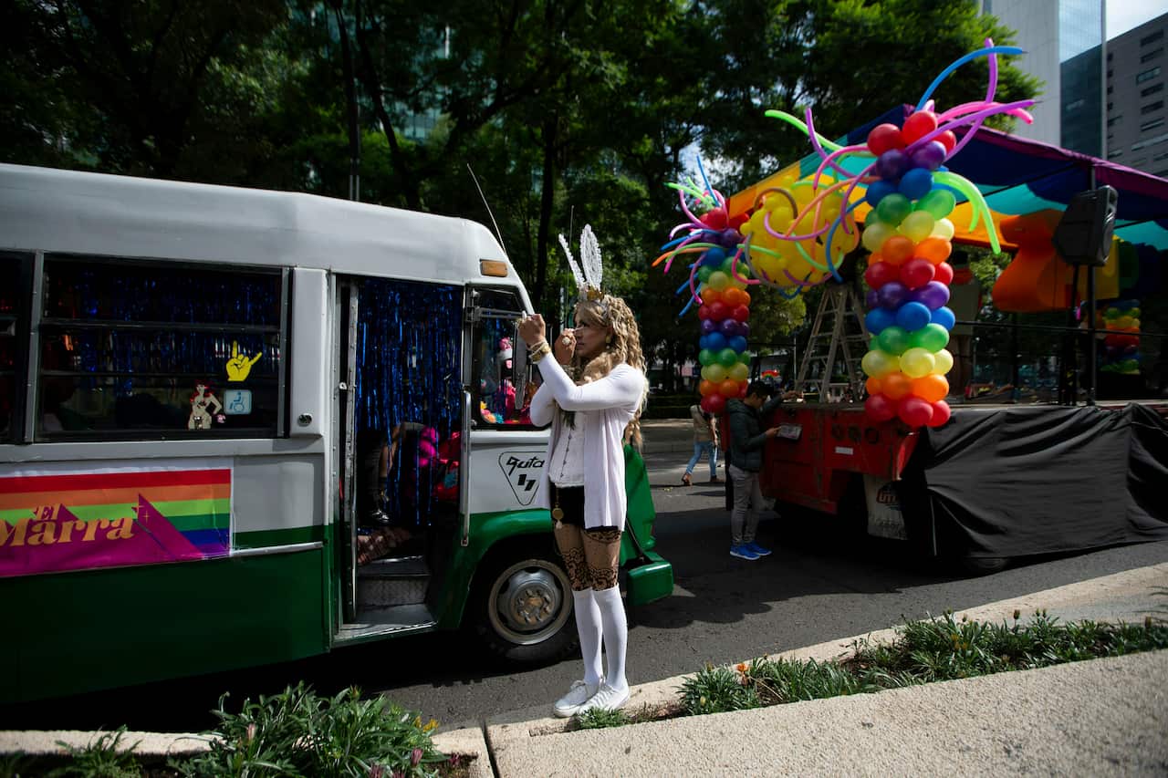A reveler applies make up prior the gay pride parade in Mexico City, Mexico, Saturday, June 29, 2019. (AP Photo/Fernando Llano)