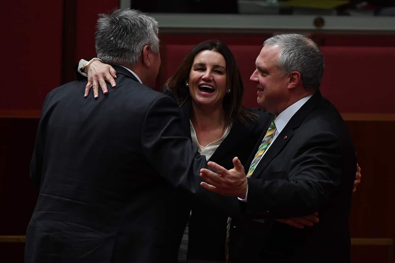 entre Alliance senators Rex Patrick and Stirling Griff and independent Senator Jacqui Lambie (centre) celebrate the end of the first sitting of Parliament. 