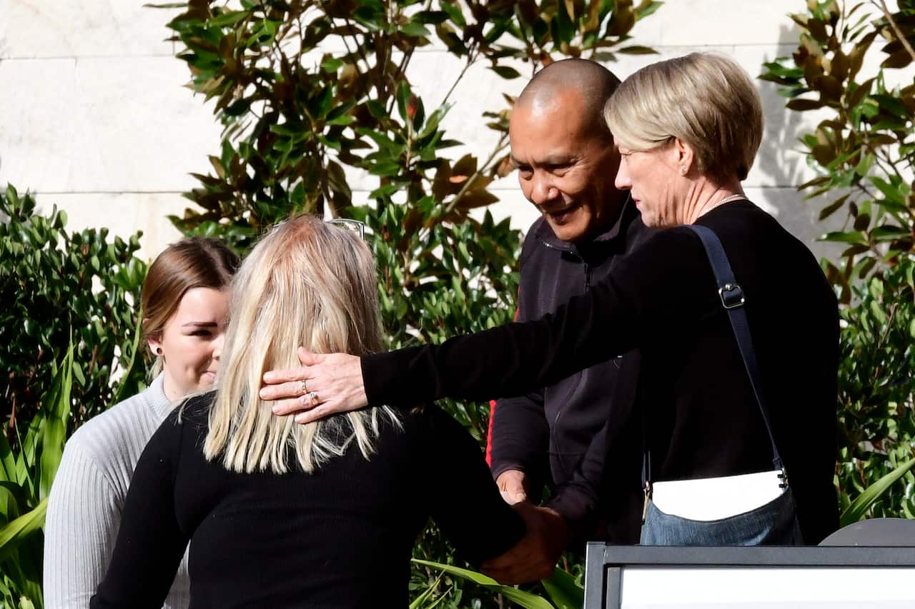 John and Julie Tam comfort other attendees at the inquest into the deaths of six young people at music festivals from 2017-19.