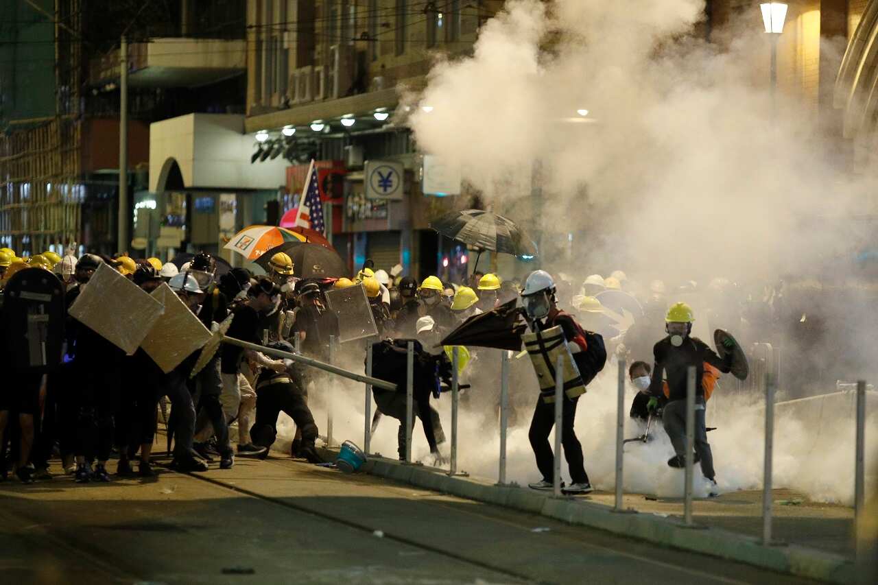 Hong Kong protesters react to teargas.