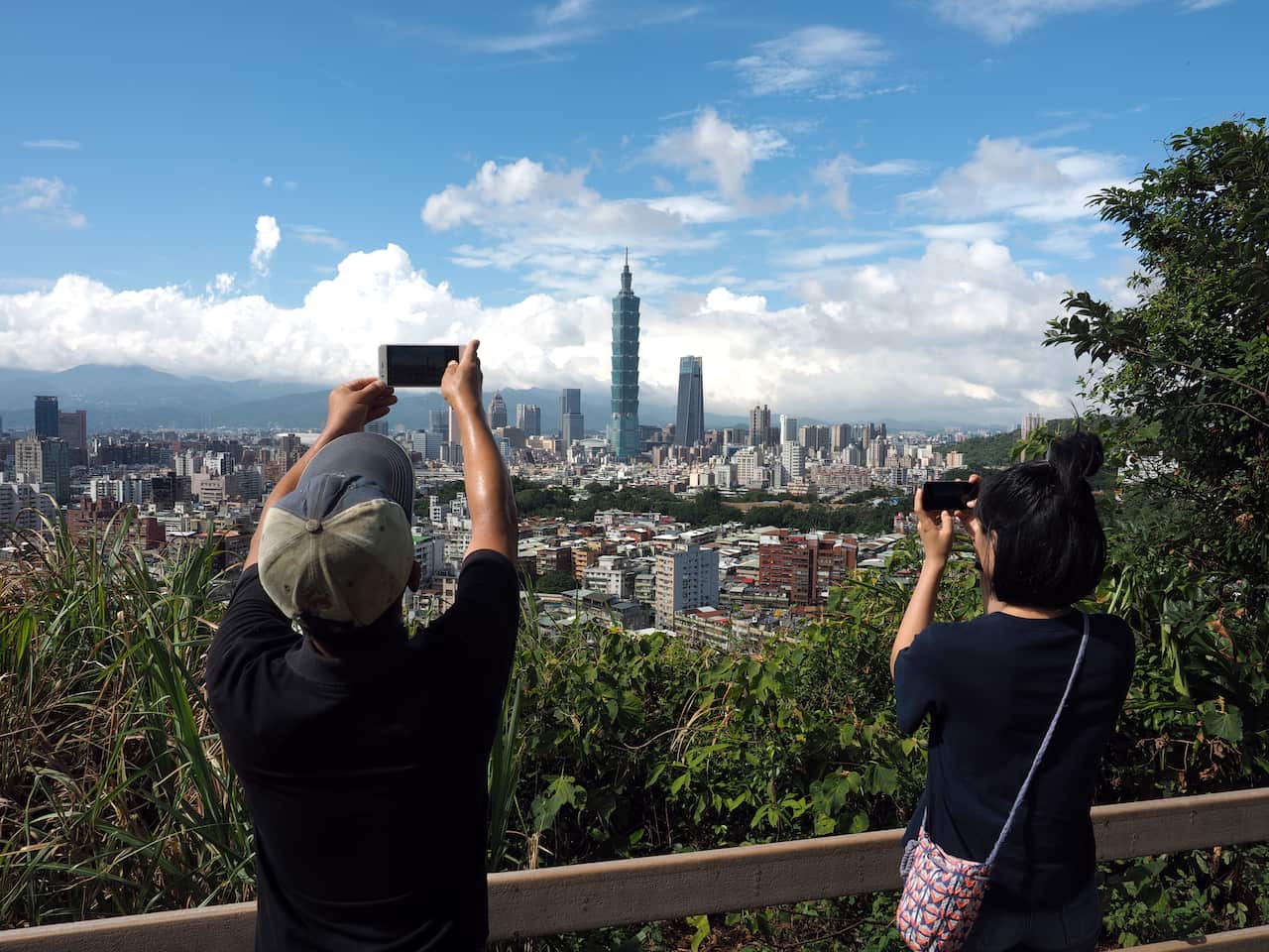 Tourists take photo of the Taipei 101skyscraper in Taipei, Taiwan.