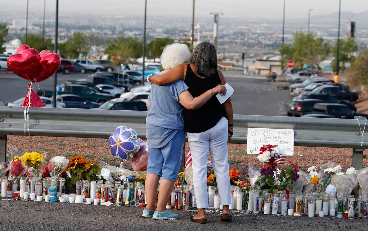 Emma Del Valle hugs Brenda Castaneda at a make shift memorial in El Paso. 