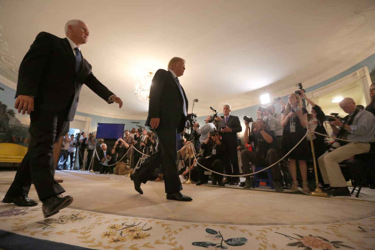 epa07758002 US President Donald J. Trump and US Vice President Mike Pence (L) depart after Trump made a statement at the White House in Washington, DC, USA, on 05 August 2019 in response to two separate shooting incidents. EPA/Chris Kleponis / POOL