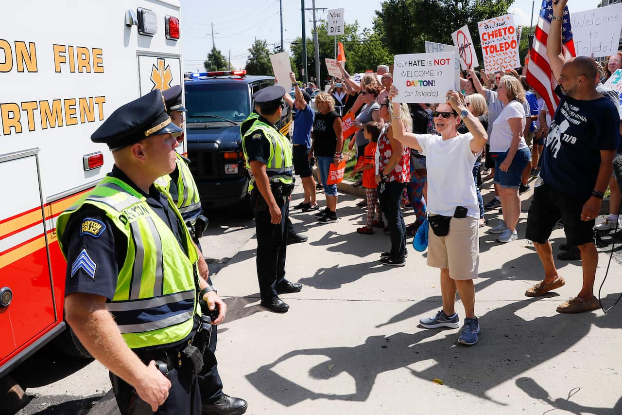 Demonstrators chant as they protest the arrival of President Donald Trump outside Miami Valley Hospital.