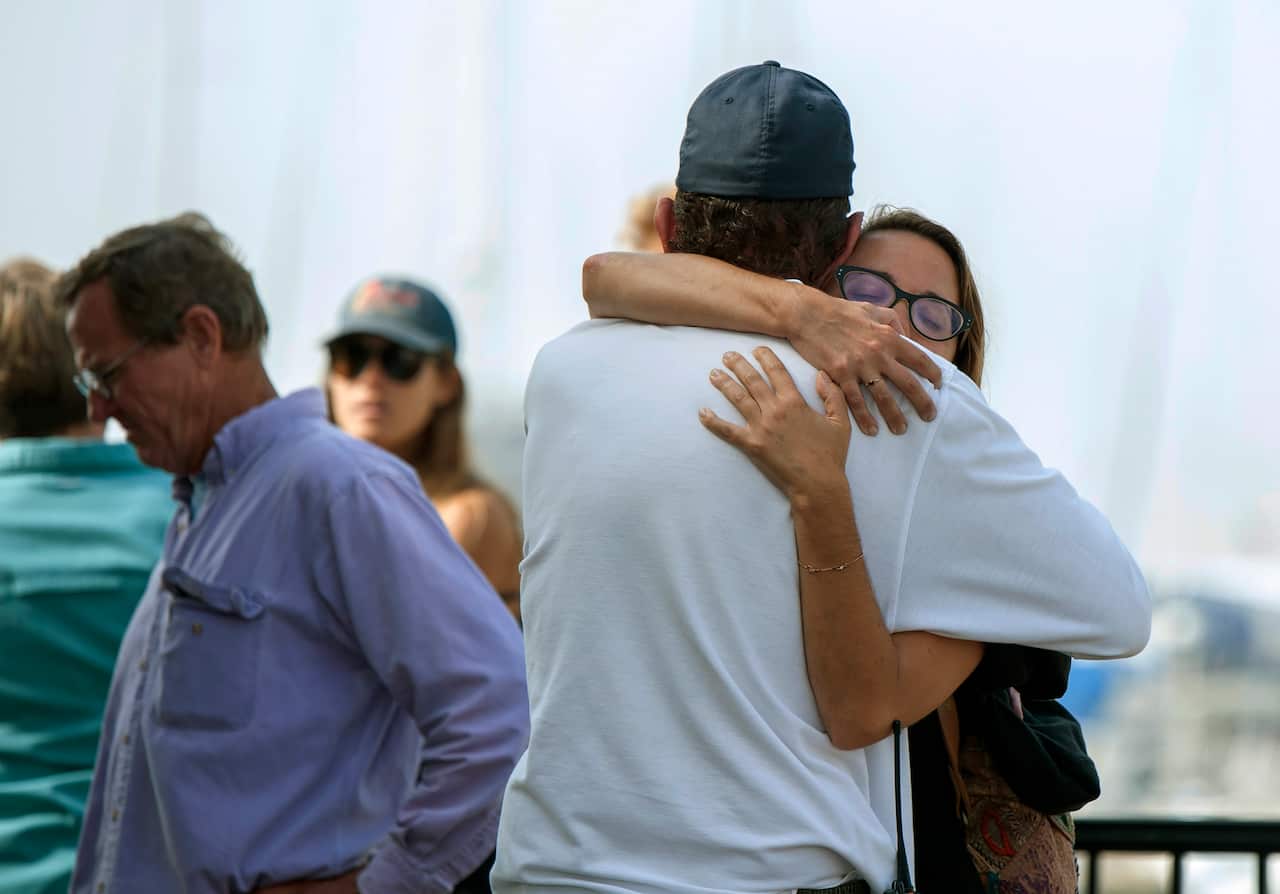 People hug each other as they await news outside of the Truth Aquatics office in Santa Barbara, Calif., on Monday, Sept. 2, 2019. 