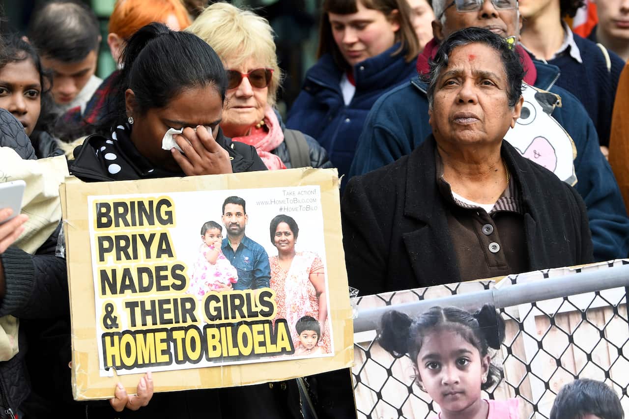 A supporter reacts during a vigil for the Tamil family awaiting a court decision.