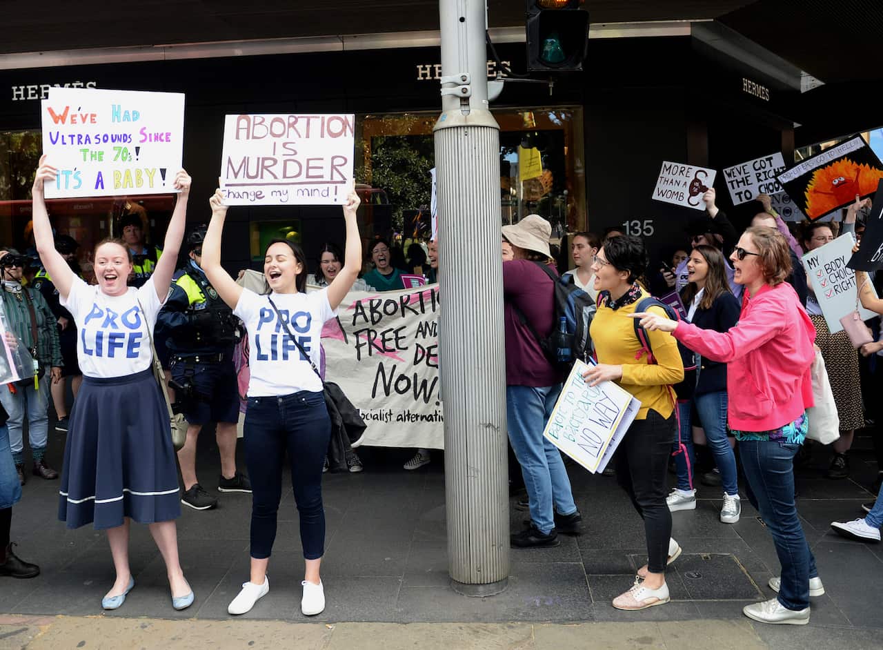 Anti-abortion and pro-choice supporters face off after a rally calling for the decriminalisation of abortion.