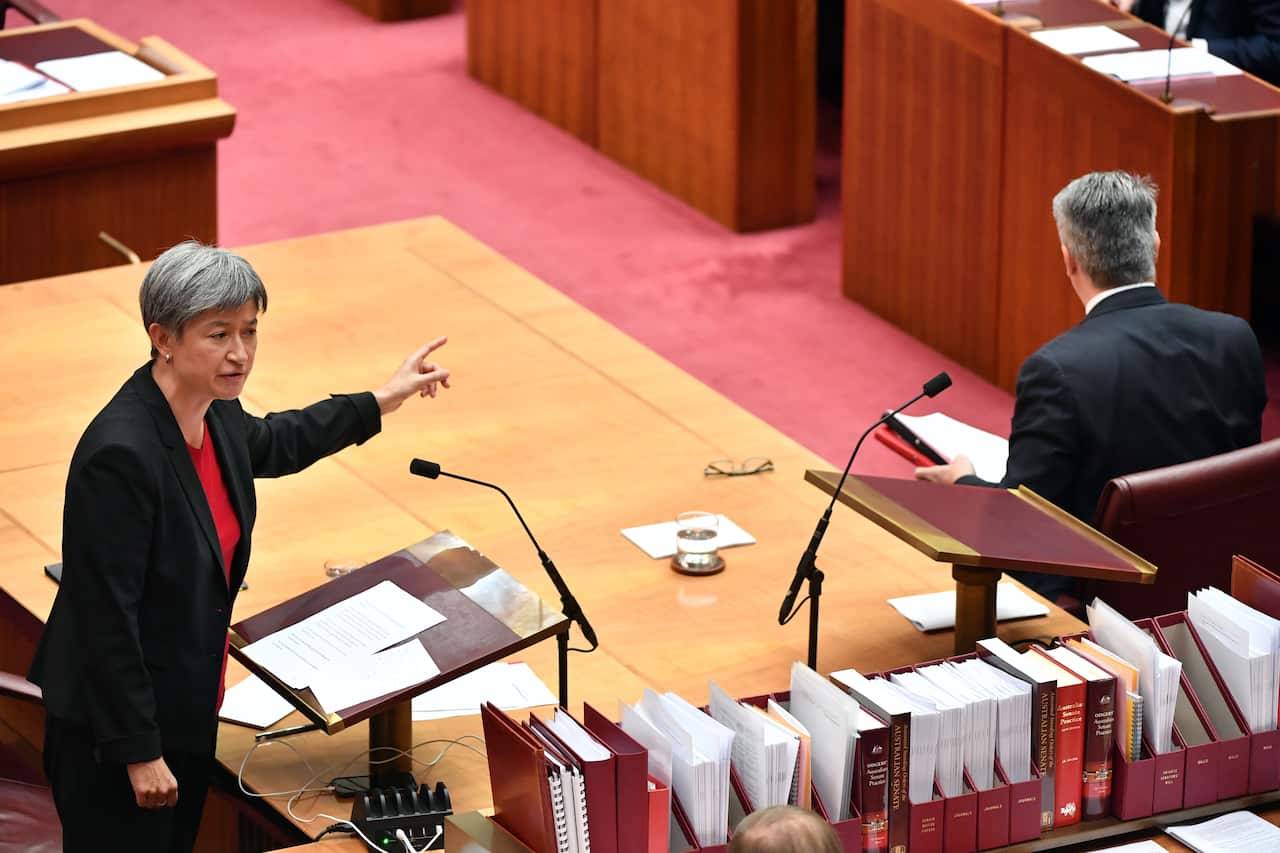 Penny Wong speaks scorns Minister for Finance Mathias Cormann (R)  in the senate.