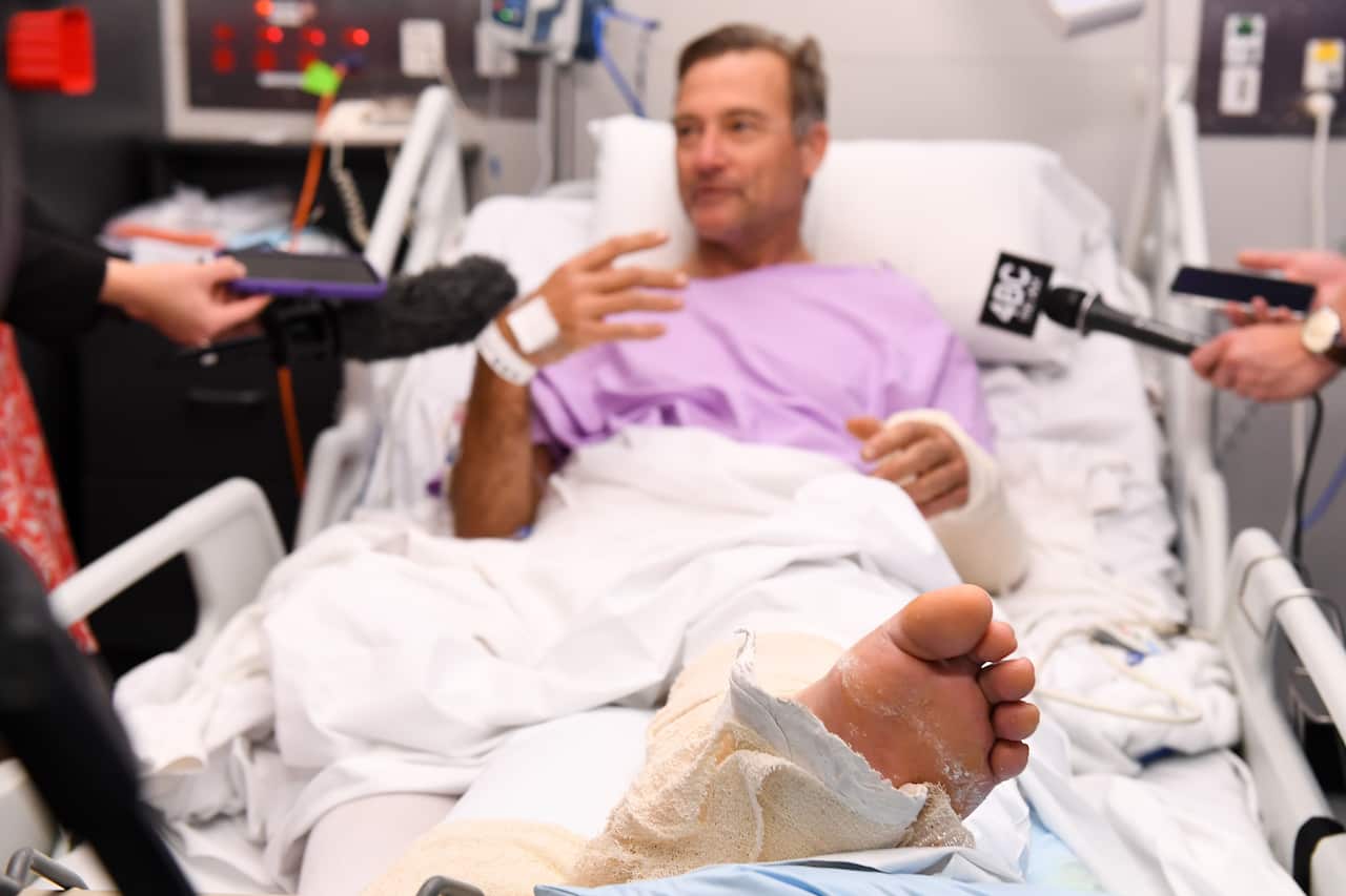 Bushwalker Neil Parker snapped his leg in two after slipping down a waterfall. 