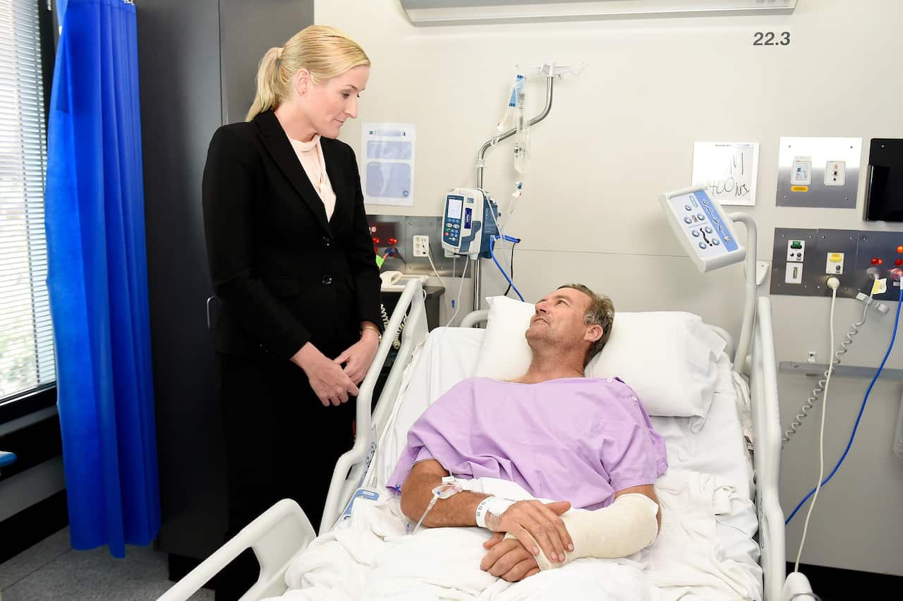 Surgeon Nicola Ward and bushwalker Neil Parker speak at Princess Alexandra Hospital in Brisbane.