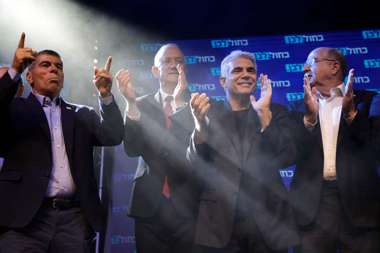 Blue and White party leaders, from the left, Gabi Ashkenazi, Benny Gantz, Yair Lapid and Moshe Ya'alon greet their supporters at party headquarters.