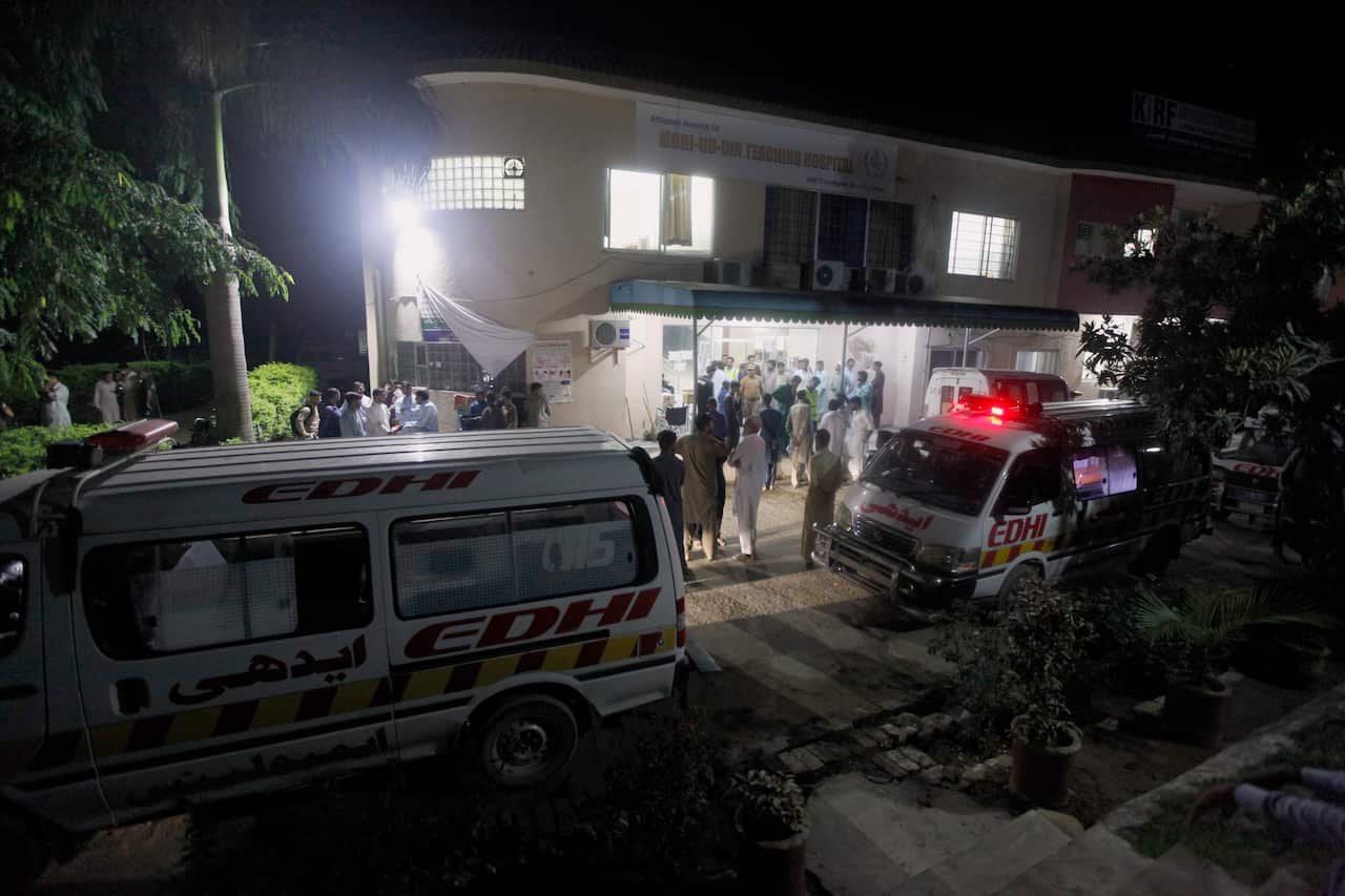 People gather at a hospital following a powerful earthquake in Jatlan.