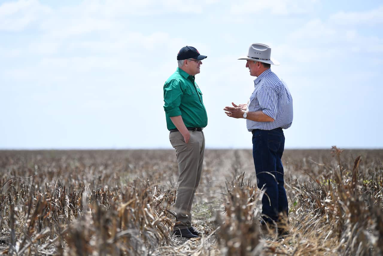 Australian Prime Minister Scott Morrison (left) chats to farmer David Gooding on his drought-affected property near Dalby, Queensland, Friday, September 2019.