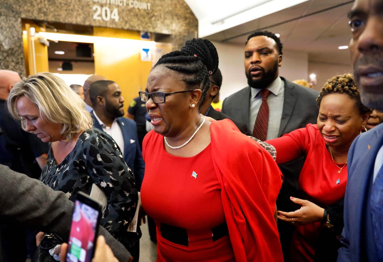 Botham Jean's mother, Allison Jean (centre) leaves the 204th District Court after fired Dallas police Officer Amber Guyger was found guilty of murder.