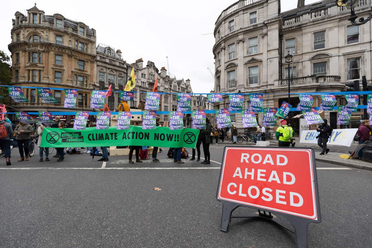 Extinction Rebellion protesters block the road in Trafalgar Square in London.