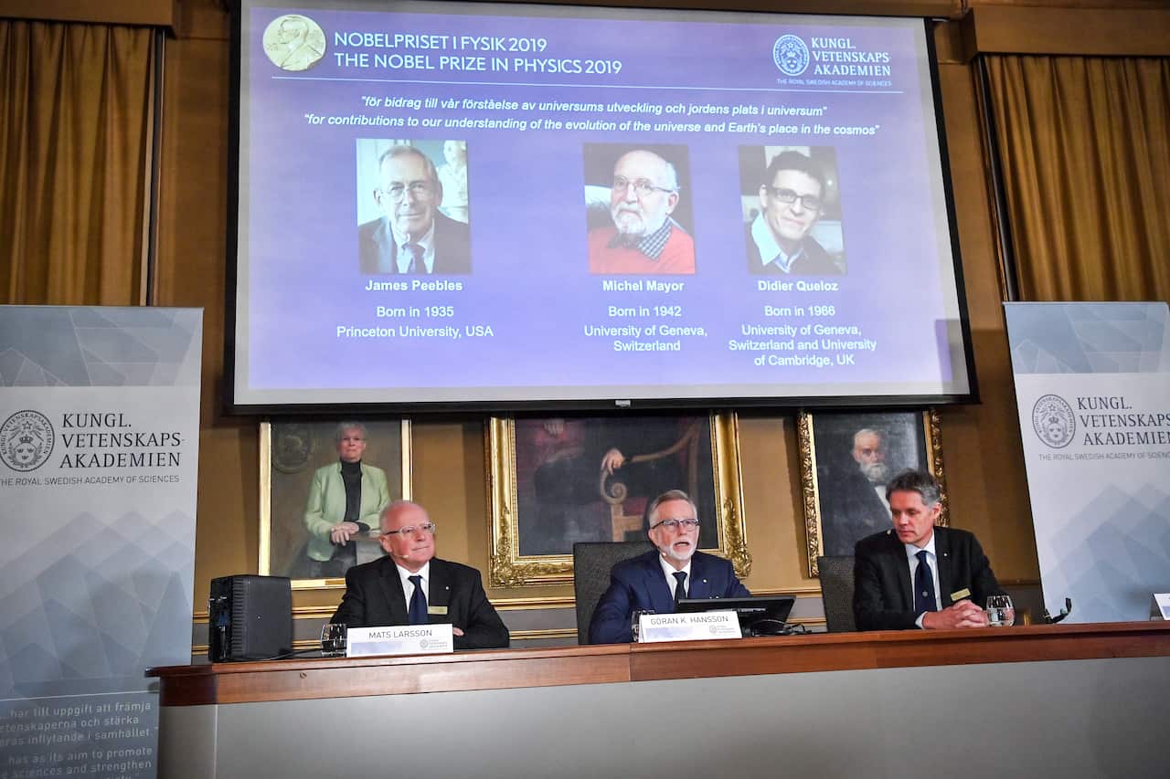Goran K. Hansson (C), Secretary General of the Royal Swedish Academy of Sciences, and academy members Mats Larsson (L) and Ulf Danielsson, announce winners.