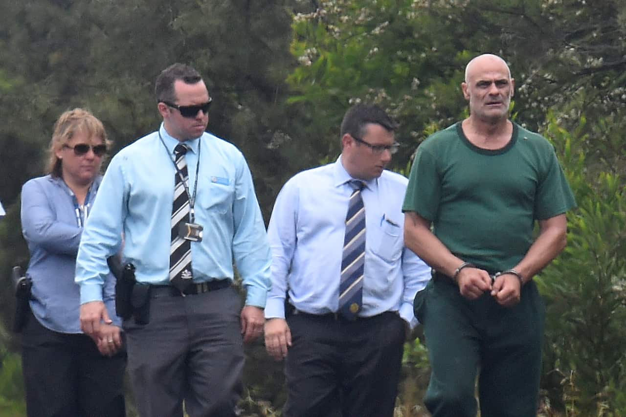NSW Police escort Vinzent Tarantino (right) south of Sydney, 23 November 2016. 