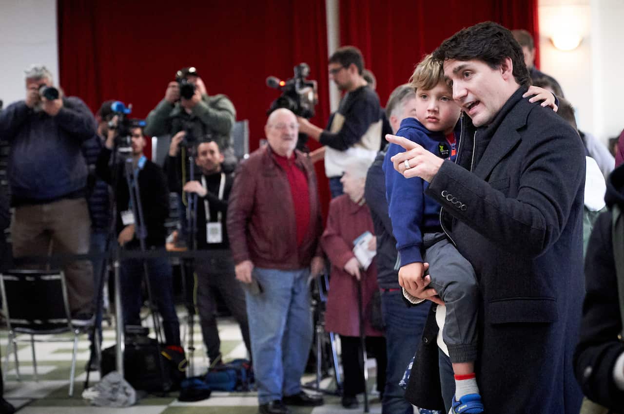 epa07938853 Canadian Prime Minister and Liberal Party leader Justin Trudeau wait in line with his son Hadrien at the polling station during the country's 43rd general election day in Montreal, Quebec, Canada, 21 October 2019.  EPA/VALERIE BLUM