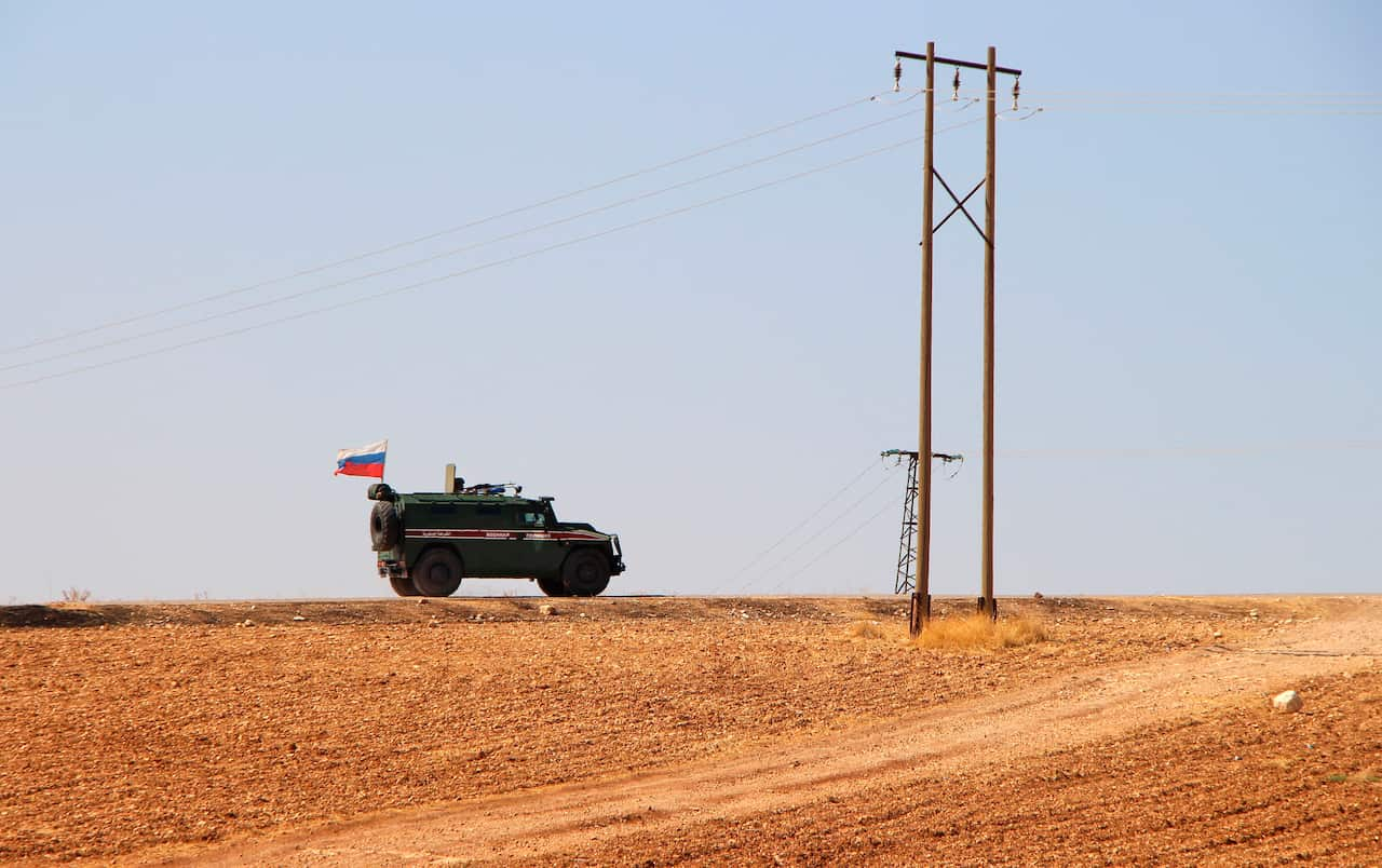 Russian forces armored vehicles patrol the Syrian border in Kobani.