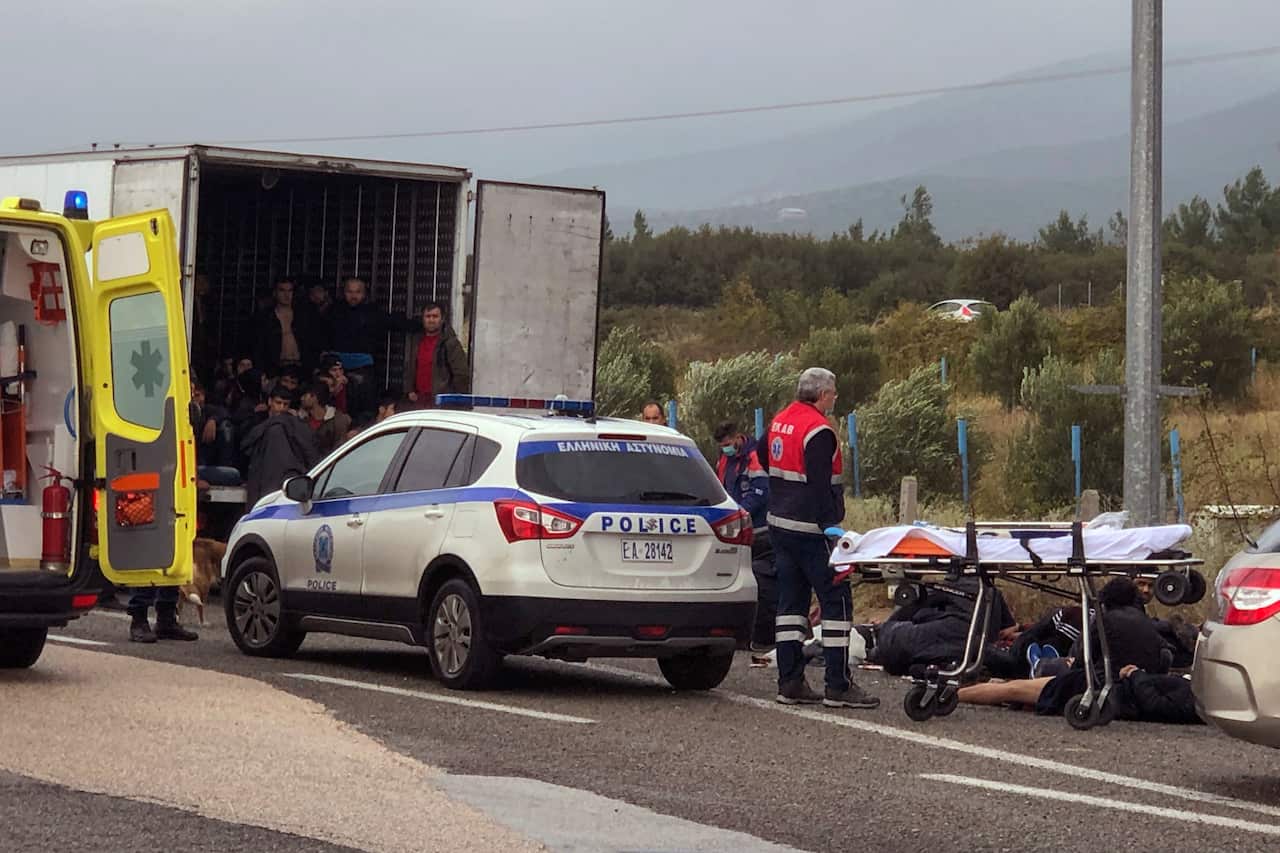 Migrants are seen inside a truck found by police, as ambulance stuff arrive to the scene near the town of Xanthi, on Monday, Nov. 4, 2019.