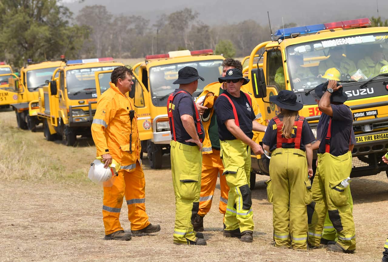 Rural firefighters are seen preparing to fight fires at Spicers Gap, south west of Brisbane.
