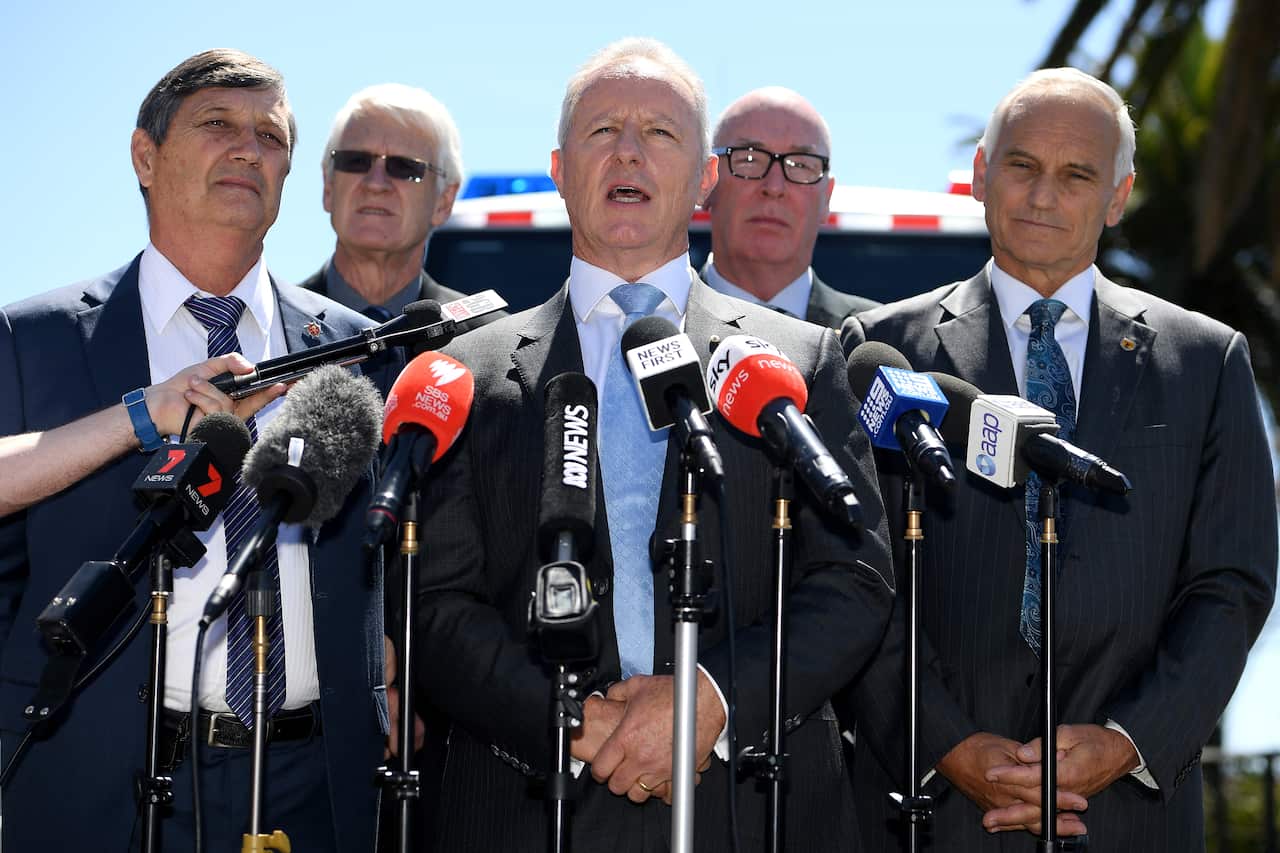 Former NSW Fire and Rescue Commissioner Greg Mullins (centre) along with former emergency services chiefs address the media.