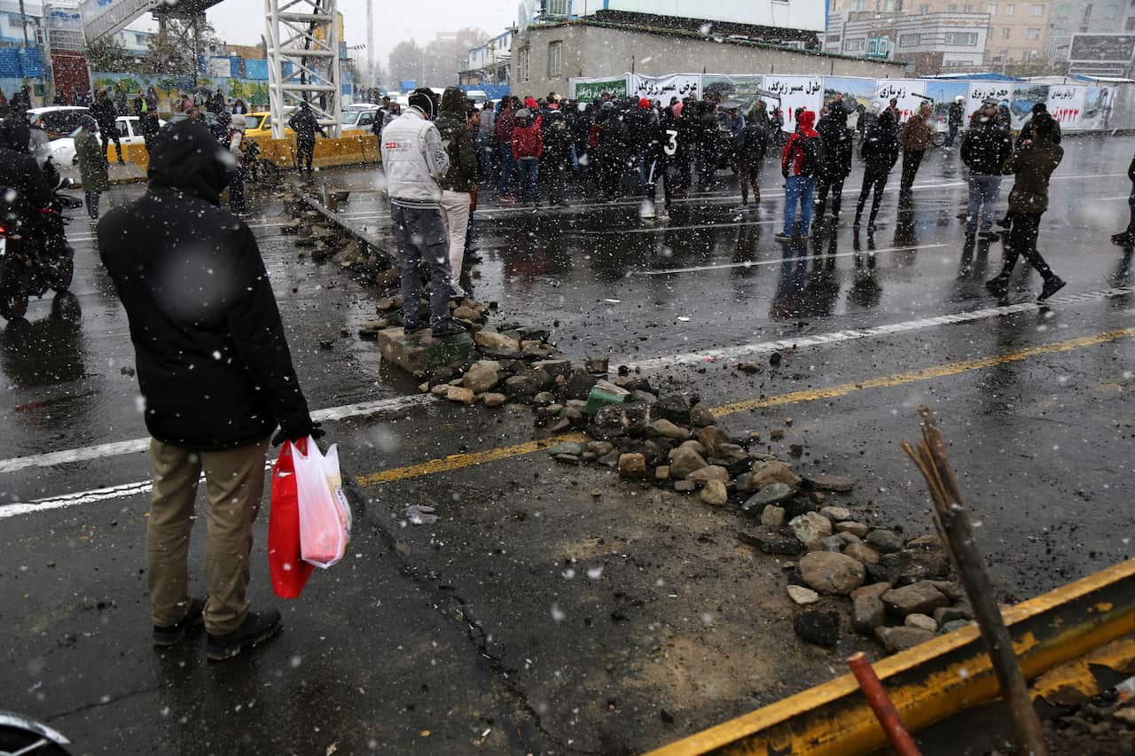 A road is blocked by protesters.