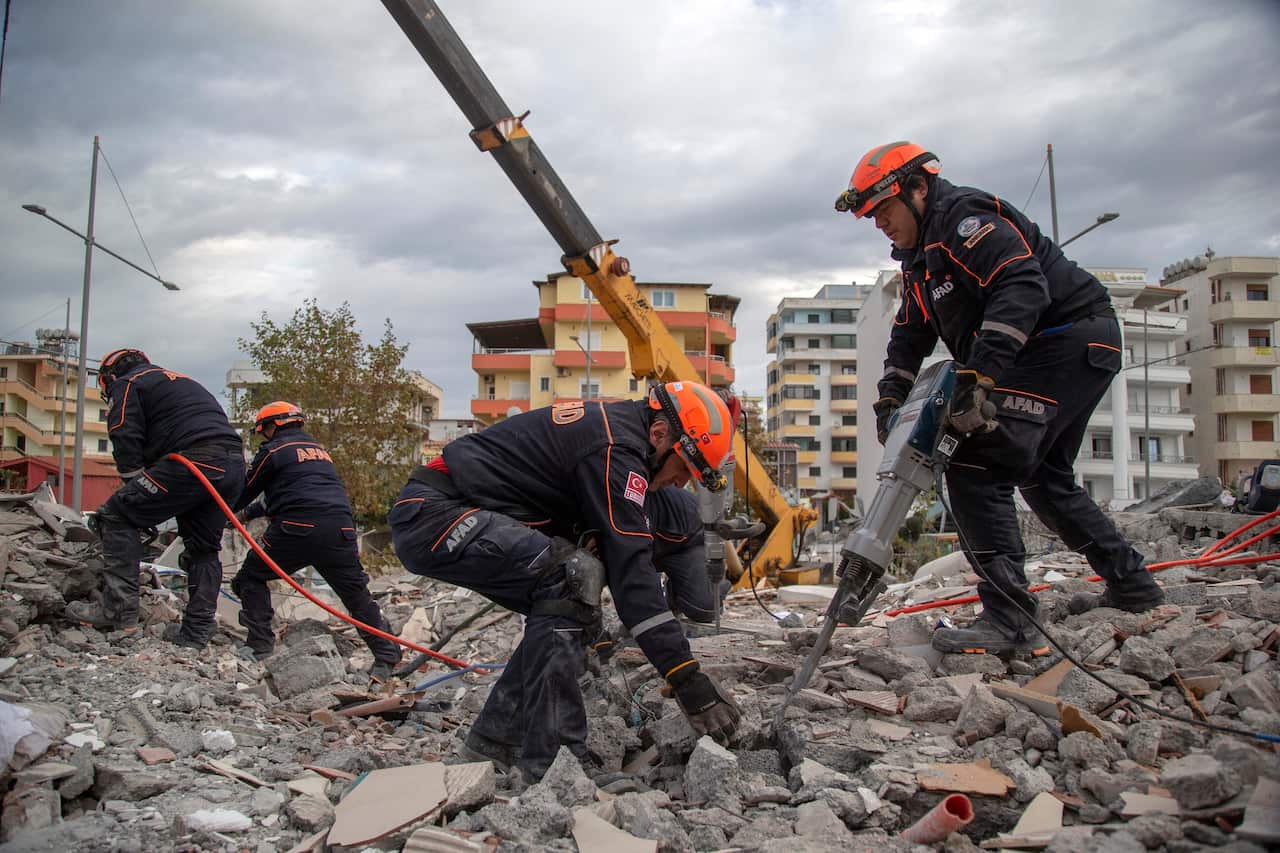 Turkish rescuers search at a collapsed building in Durres, western Albania.