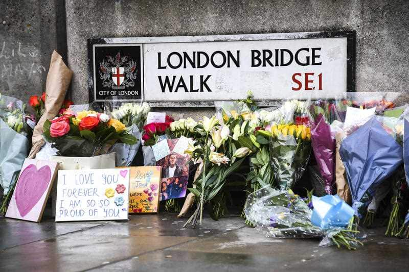 Flowers and a pictures are left in memory of Jack Merritt, the first person named as a victim of Friday's terror attack.