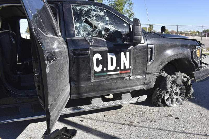 A damaged truck stands on the street after a gun battle between Mexican security forces and suspected cartel gunmen, in Villa Union, Mexico