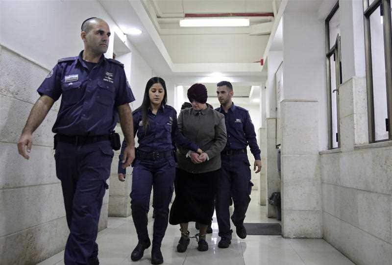 In this Feb. 27, 2018 file photo, Australian Malka Leifer, center, is brought to a courtroom in Jerusalem