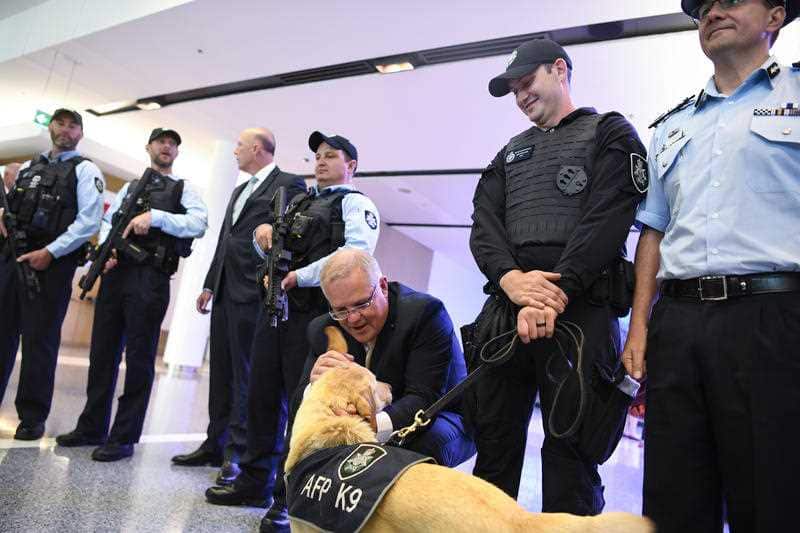 Australian Prime Minister Scott Morrison (centre) poses for photographs with Australian Federal Police (AFP) officers at Canberra Airport