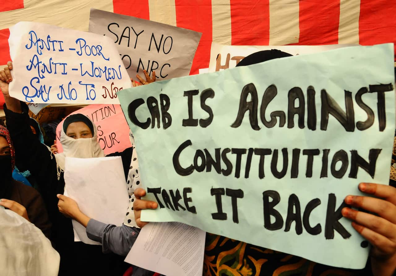 Protesters hold placards during a protest against the Citizenship Amendment Billin New Delhi, India, on Saturday, 14 December.